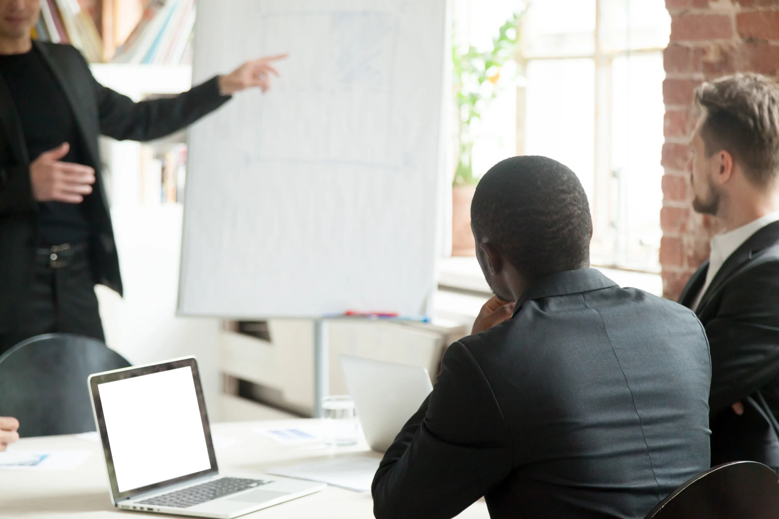 business leaders in meeting discussing leadership strategy and growth planning